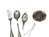 a spoon, fork, spoon and spoon rest on a white surface