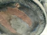 a close up of a metal object with a brown bear on it