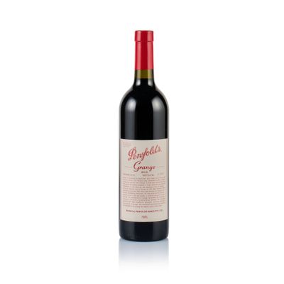 a bottle of red wine sitting on top of a white surface