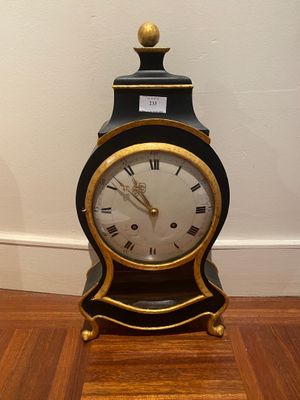 a black and gold clock with roman numerals on it