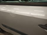 a car that is parked in a garage with its door open