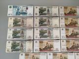 several bills of different currency are arranged on a table