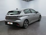 the rear end of a silver car in a white room
