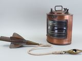 a small copper lantern with a rope around it