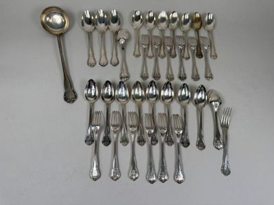 a lot of silver spoons and spoons on the table