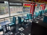 tables and chairs in a restaurant with a view of the street