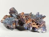 blue and brown crystals on a white surface with a white background