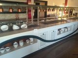 a long counter with cups on it in a restaurant
