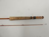 two different types of fishing rods on a white surface