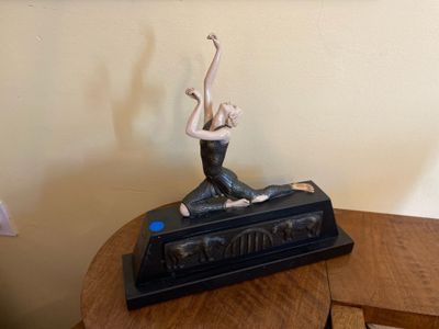 a statue of a woman sitting on top of a table