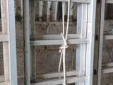 a ladder with a rope attached to it in a room