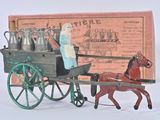 a figurine of a woman riding in a horse drawn carriage