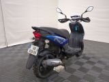 a scooter that is parked on a checkered floor