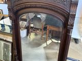 a mirror that is sitting on the floor next to a chair