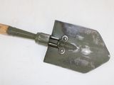 a metal shovel with a wooden handle on a white surface