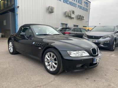 black bmw z4 convertible parked in front of a bmw dealership