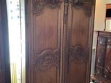 an image of a bedroom with a large wooden armoire