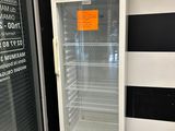 a refrigerator that is sitting outside of a building