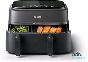 philips air fryer with vegetables and meat in it on a white background