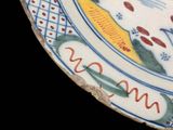 a blue and white plate with a picture of a bird on it
