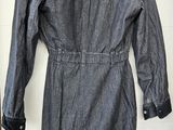 denim dress with hoodie on hanger in front of white door