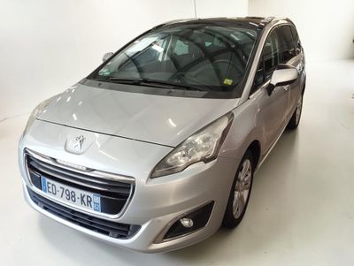 the small silver car is parked in a white room