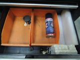 a can of spray sitting in the drawer of a car