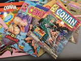 a lot of comic books sitting on a table