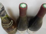 three bottles of wine sitting on a shelf next to each other