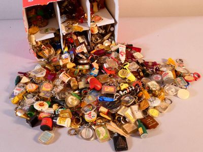 a pile of assorted bottle caps and key chains