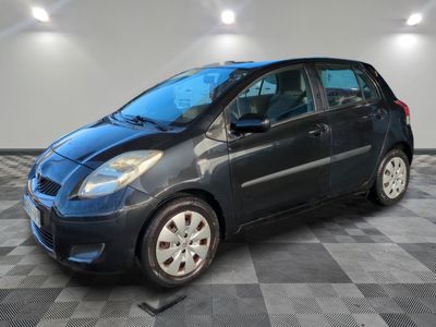 a picture of a small blue car parked in a garage