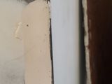 a close up of a window with peeling paint on it