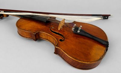 a violin that is sitting on a white surface