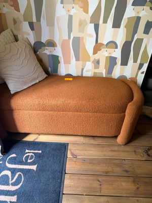 a couch and a rug in the corner of a room