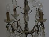 a person that is holding a chandelier in their hand