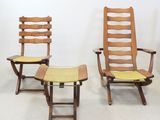 three chairs and a table in a room with a white wall