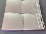 four white cards in a silver box on a gray surface