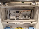 a close up of an electrical panel with a button on it