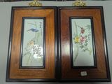 two framed pictures of birds and flowers hanging on a wall