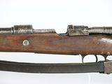 an old rifle with a wooden barrel and a metal handle