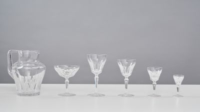 a group of wine glasses and a pitcher on a table
