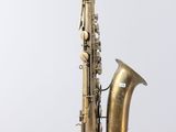 an old brass saxophone with a white background