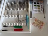 a drawer with many tools in it on a table