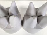 two white vases that are sitting on a table