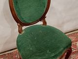 a green chair that is sitting on a red rug
