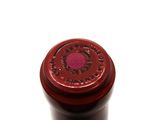 a close up of a bottle of wine on a white surface