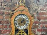 une horloge posée sur une table devant un mur de briques