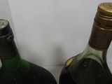 three bottles of wine are lined up in a row on a counter