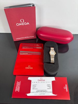 a box with a watch and a case on a table