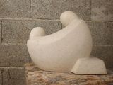 a white sculpture sitting on top of a marble table